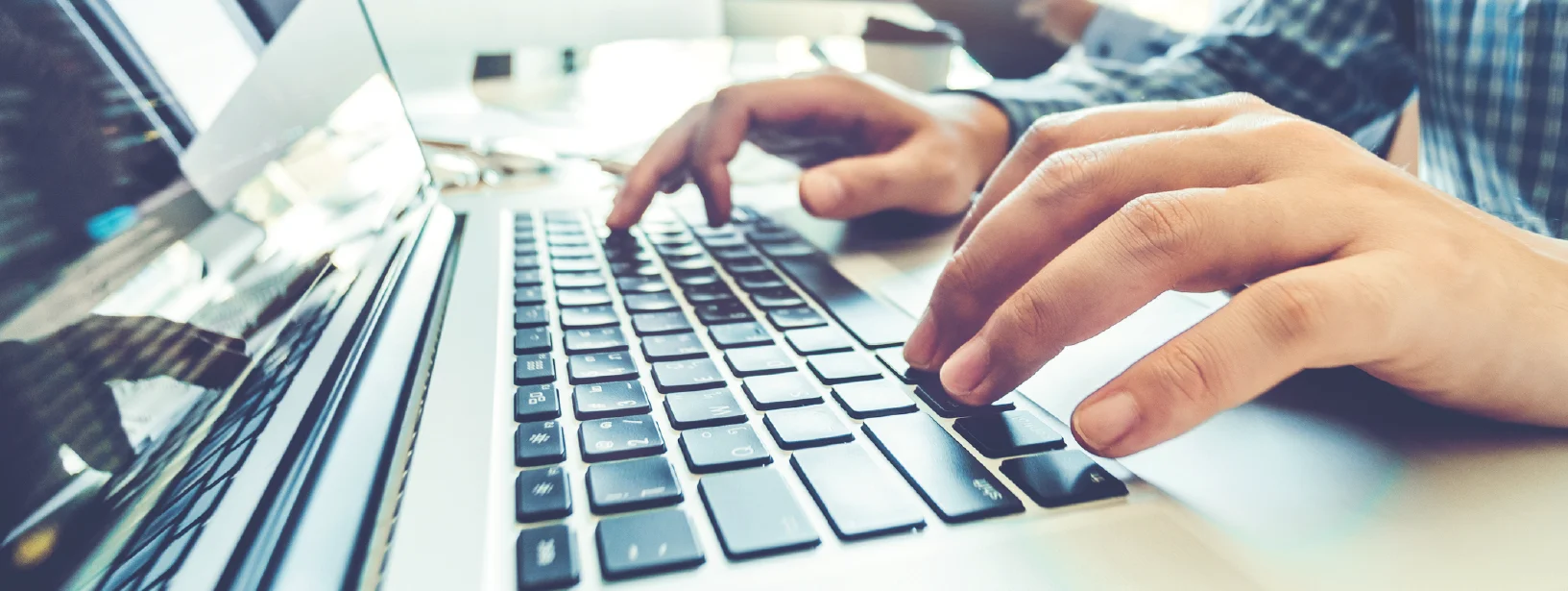 hands typing on computer keyboard